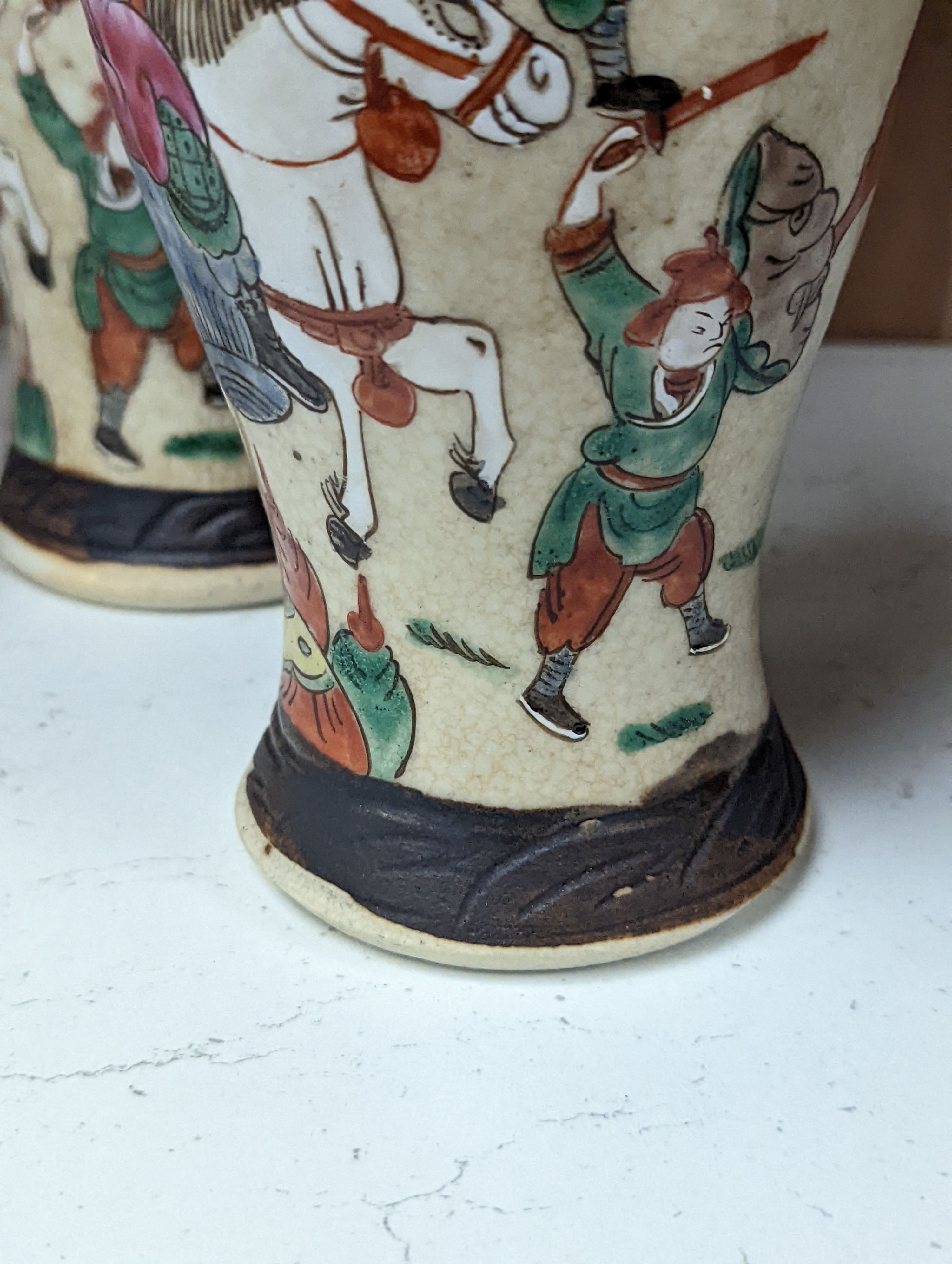 A pair of Chinese famille rose crackle glaze baluster jars and covers, 27cm.